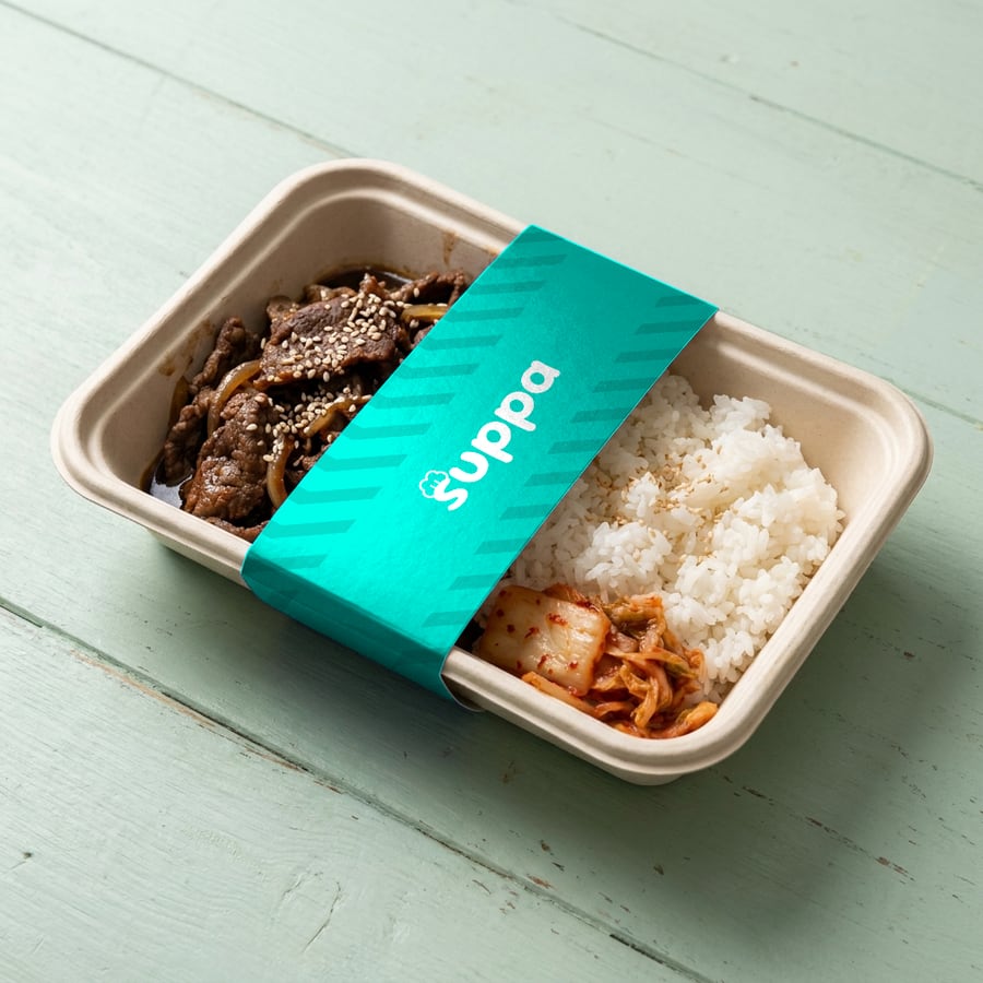 Korean beef bulgogi bowl packed in a Suppa tray with a teal striped sleeve