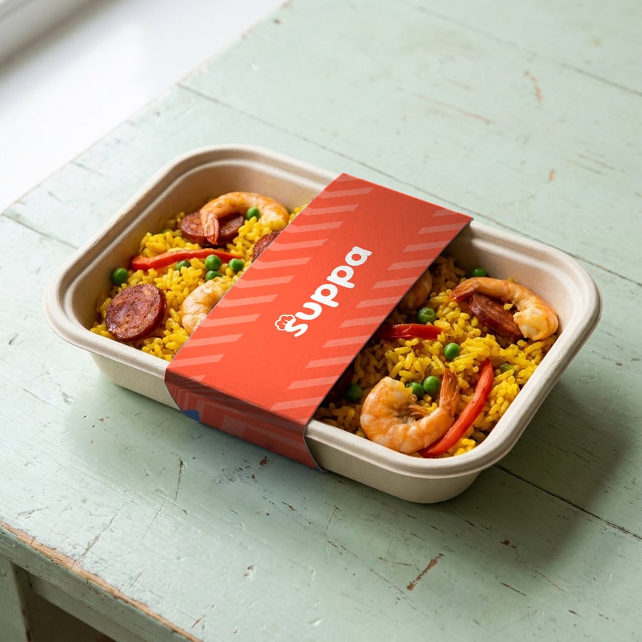Prawn and chorizo paella packed in a Suppa tray with a orange striped sleeve