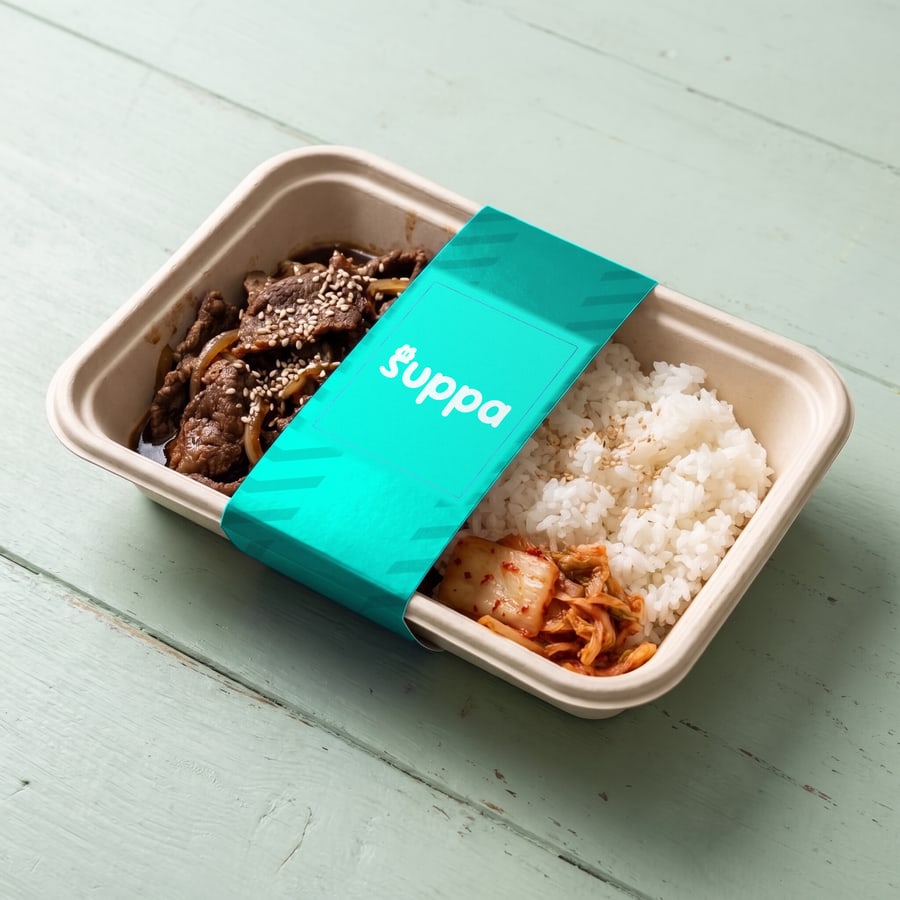 Korean beef bulgogi bowl packed in a Suppa tray with a teal striped sleeve